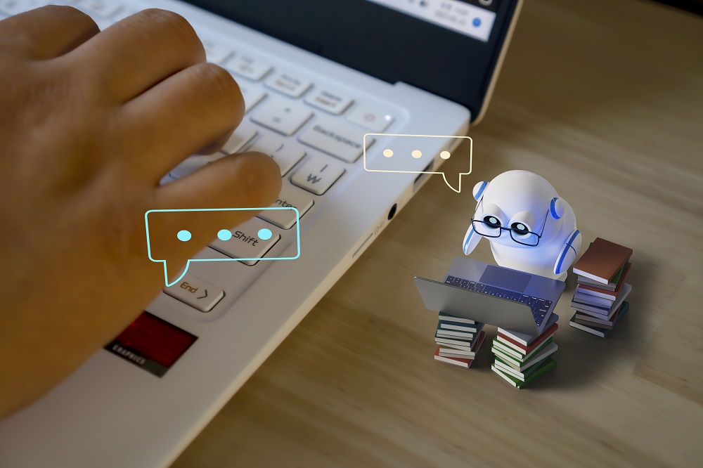 Photo by iStock, a cute robot working on a laptop.